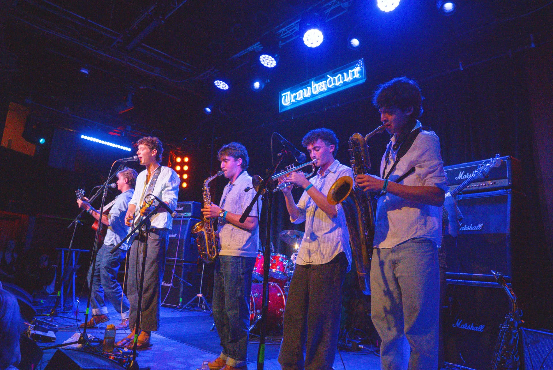 The 529s full band on stage under the Troubadour neon sign