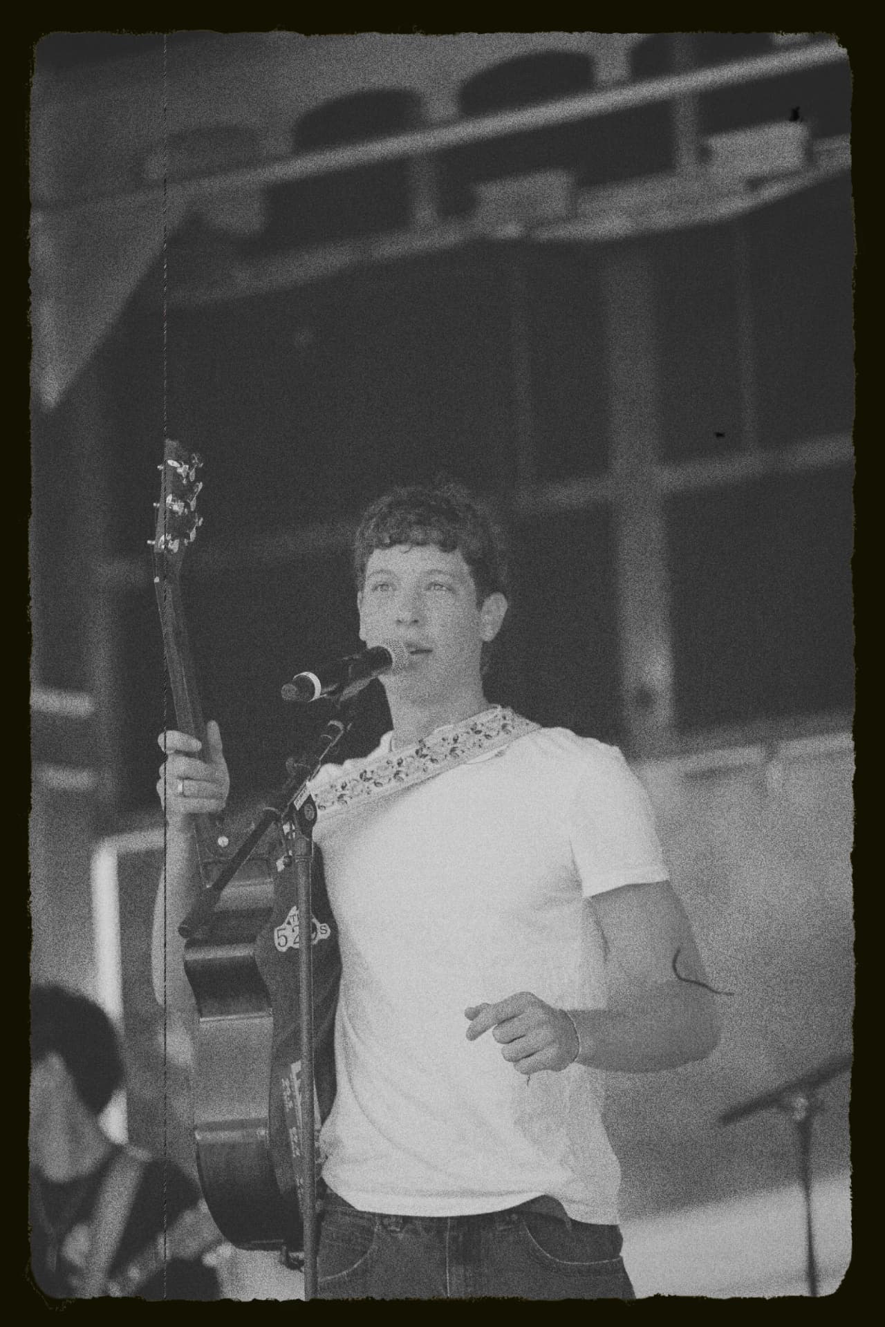 Black and white photograph of the singer at the microphone